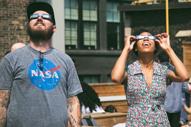 man & woman watch eclipse