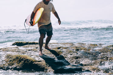 Browse Free HD Images of Man Carrying Surfboard Emerges From Ocean Waves