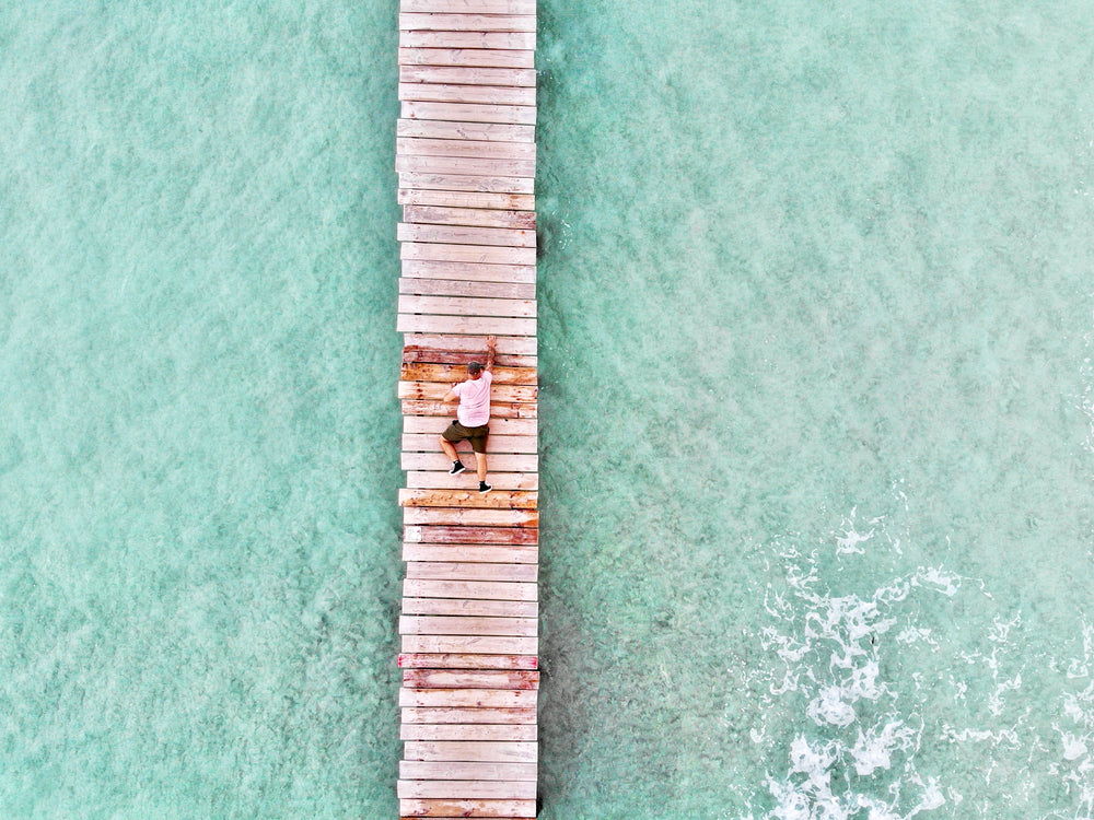 man crab walks on wooden pier