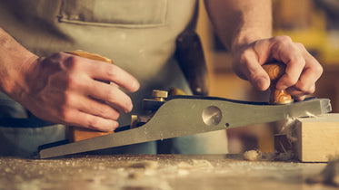 man crafting wood