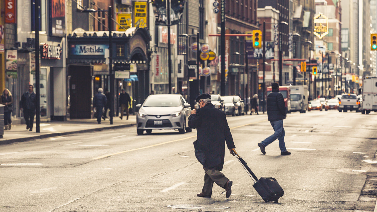 man crossing city street