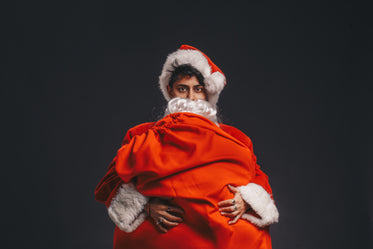 man dressed as santa clutches sack