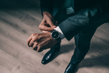 Picture of Man Fixes Shirt Cuff — Free Stock Photo