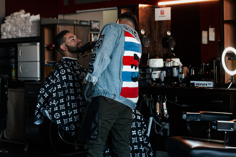 man gets his beard trimmed in a barber shop