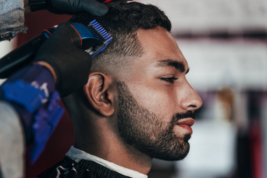 Man gets his hair trimmed at the barbershop
