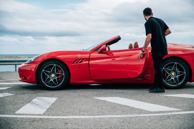 Man Getting Into Red Sports Car