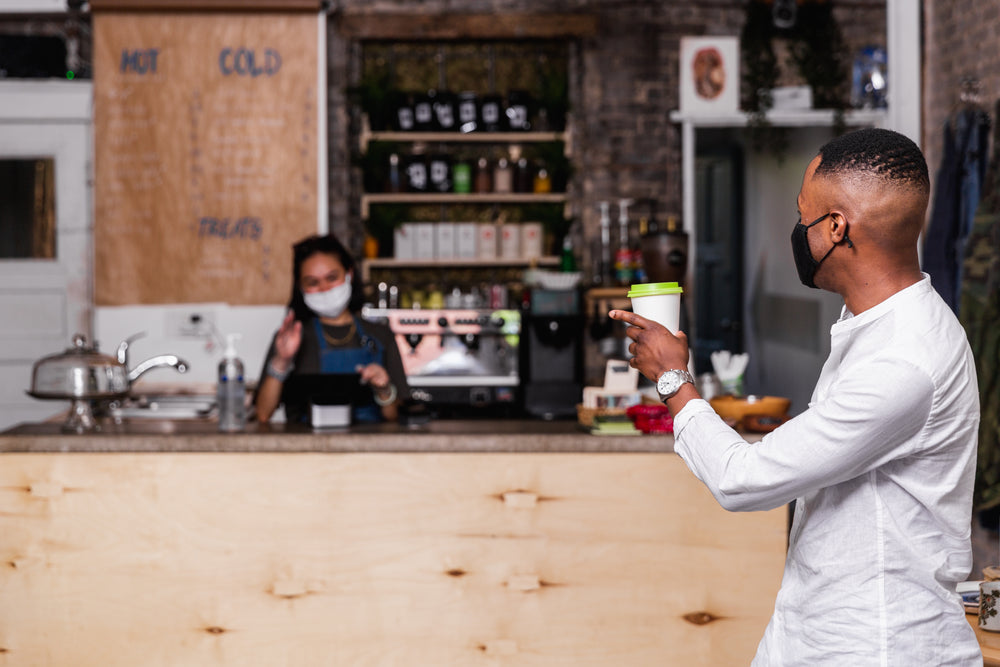 man grabs a quick coffee to go