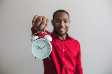 man holding clock forward