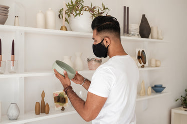 man holding green ceramic bowl