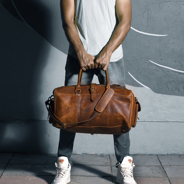 Man Holding His Leather Travel Bag