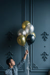 man holding party balloons