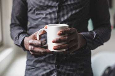 man holds mug