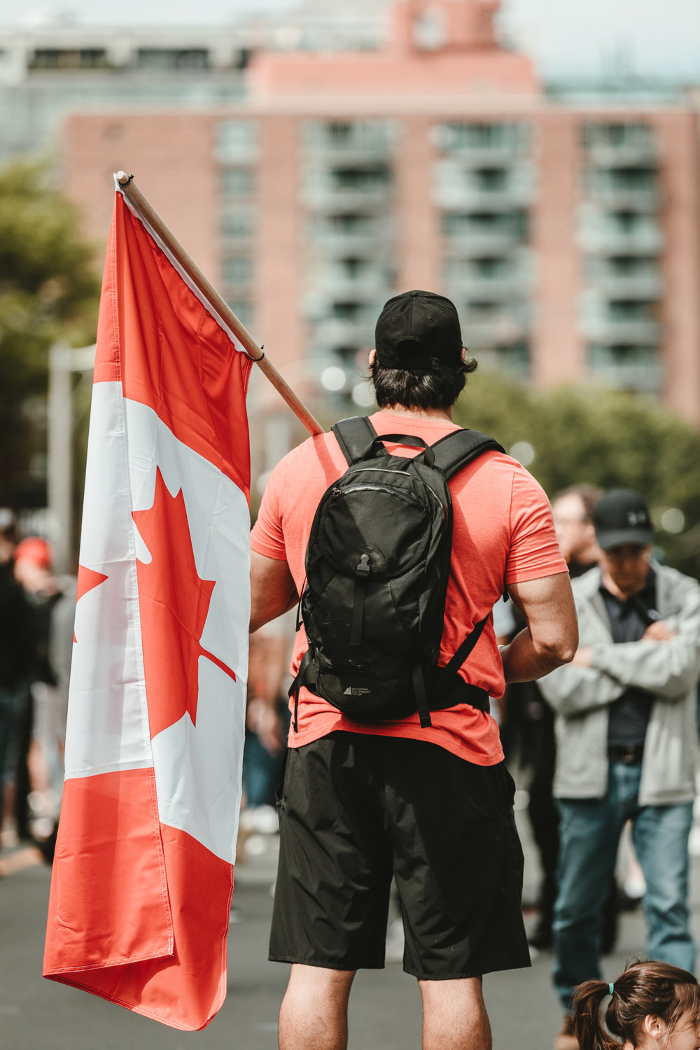 man in a crown holding a canadian flag