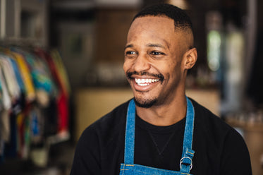 man in retail store with big smile