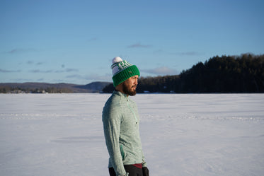 man in sunny snow field