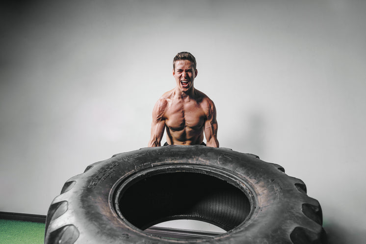 Man Lifts Tire Exercise