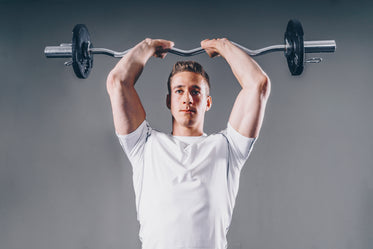 man lifts weights
