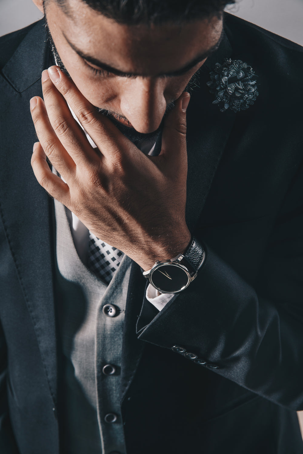 man looking down in suit