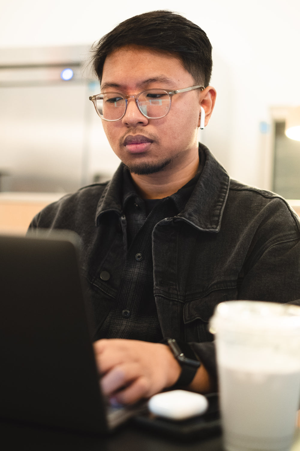 man looks at his laptop and types