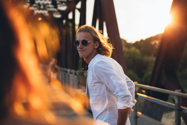 man looks at woman in sunset