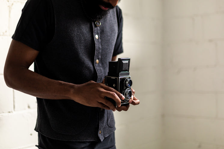 Man Looks Down Camera View Finder