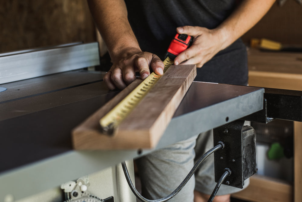 man measures wood