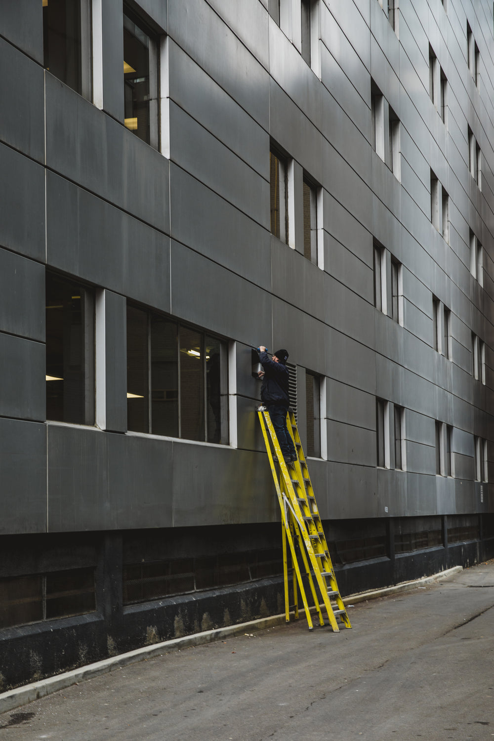 man on ladder changing outdoor light