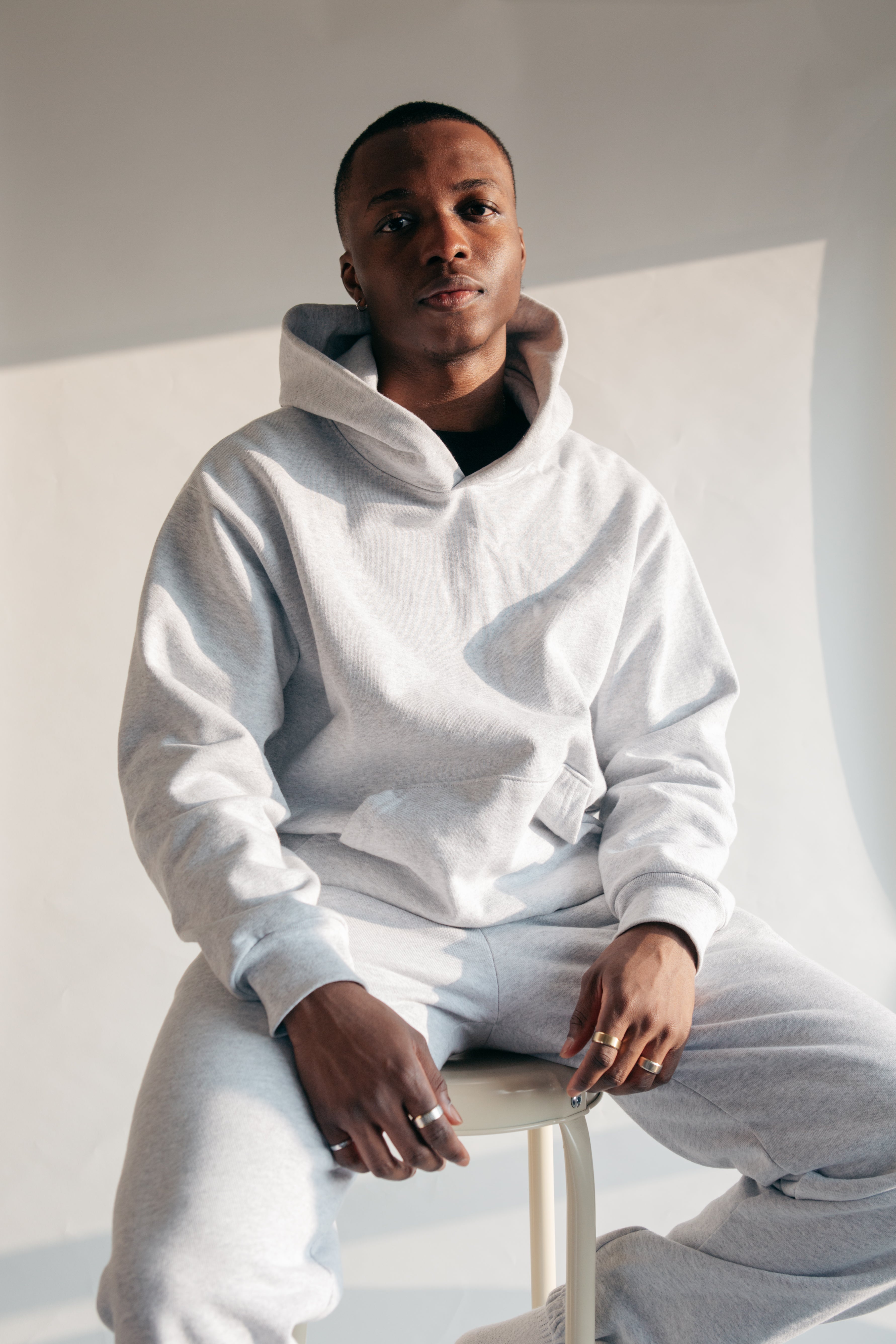 Man in white hoodie and sweatpants men’s fashion apparel shoot Stock  Photo