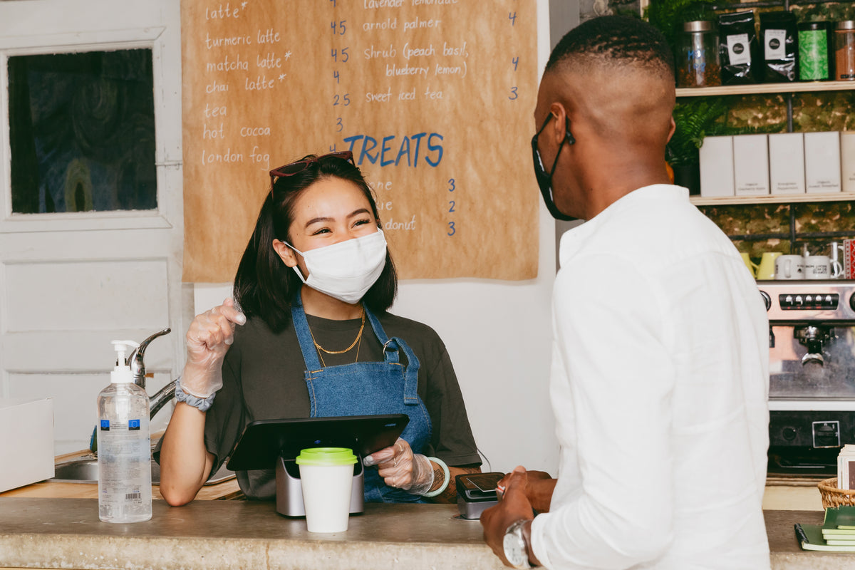 man orders coffee while wearing face mask