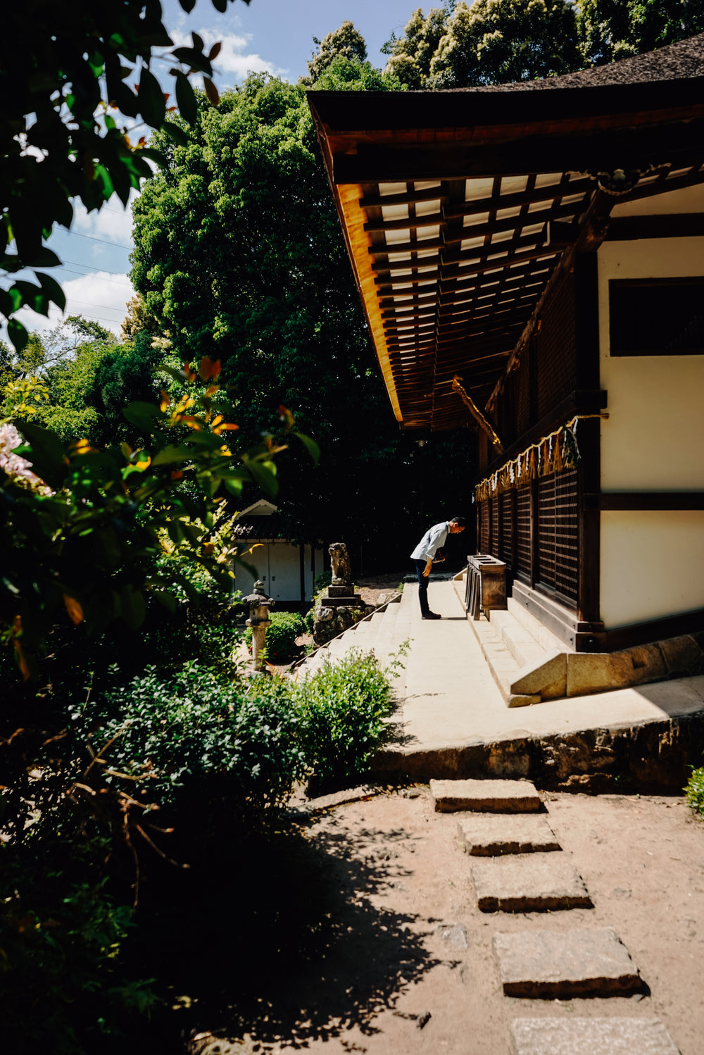 man pays respects before entering a minka