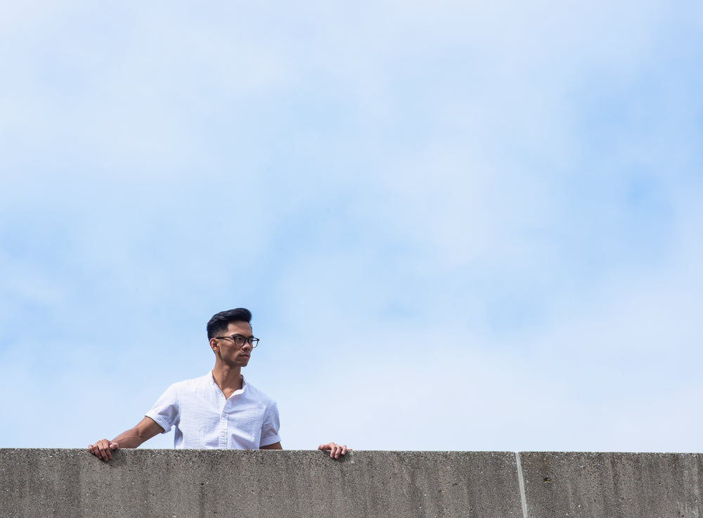 man peers over wall