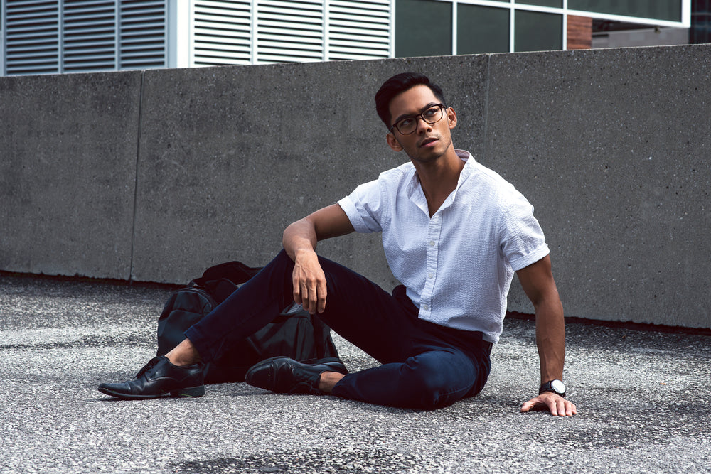 man poses on roof looking up