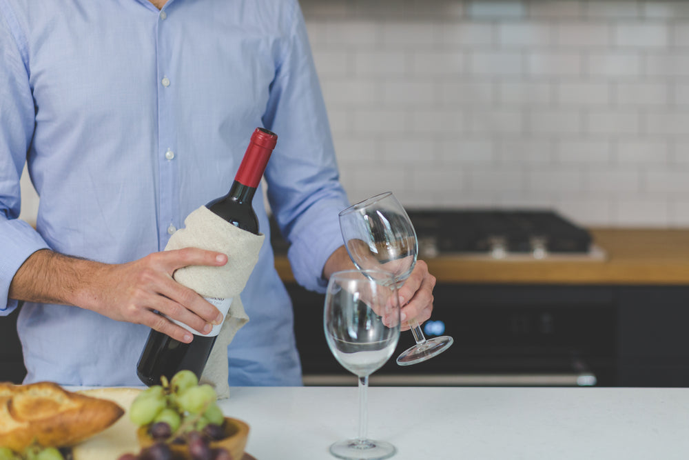 man pouring red wine