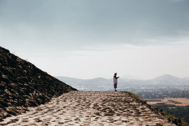 man prays on stone temple ledge