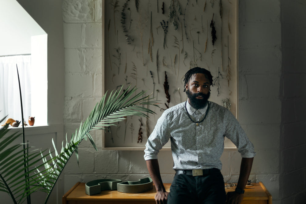 man rests against wooden table