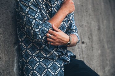 man rolls up shirt sleeves