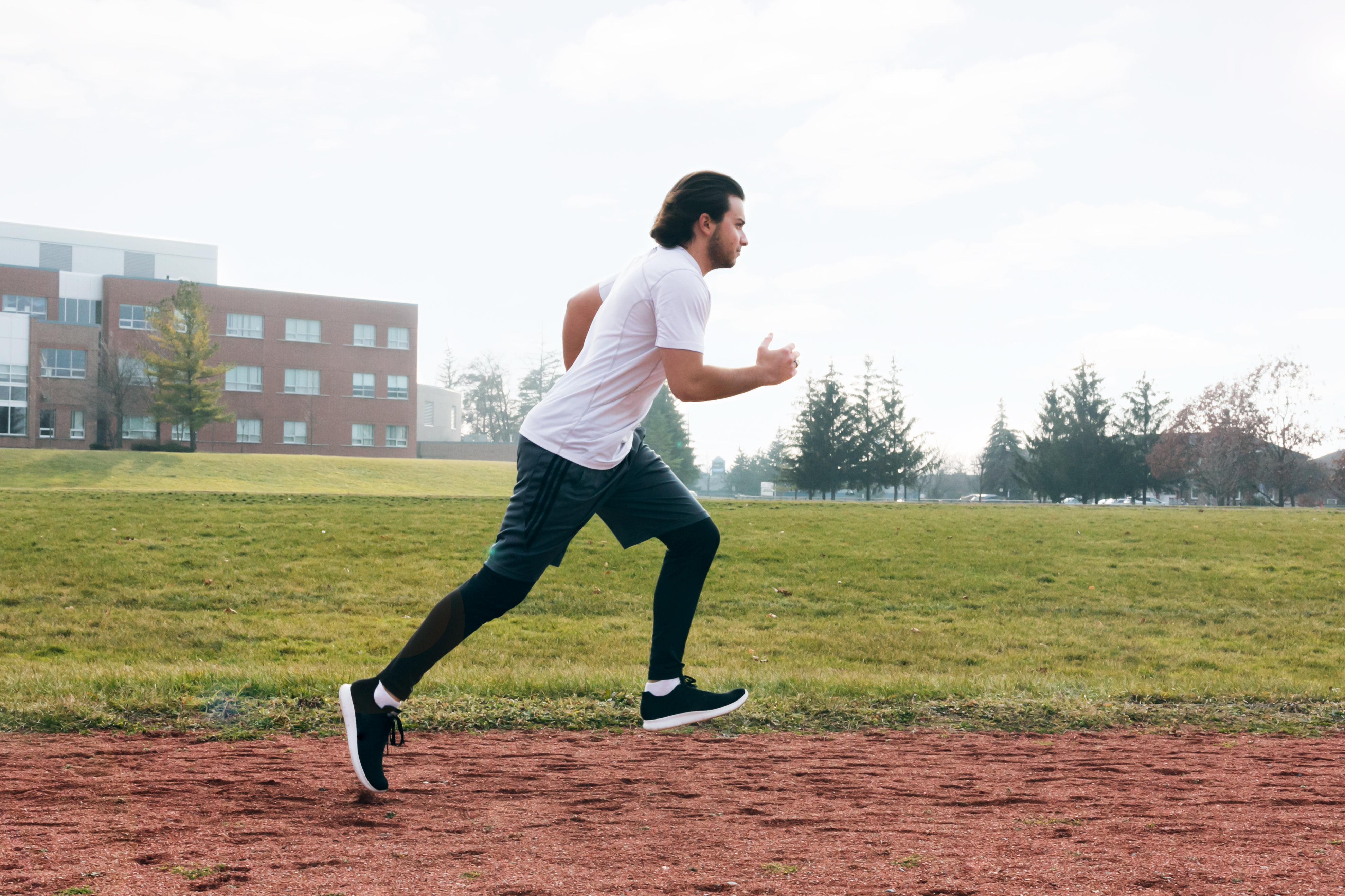 Legs Running On Track