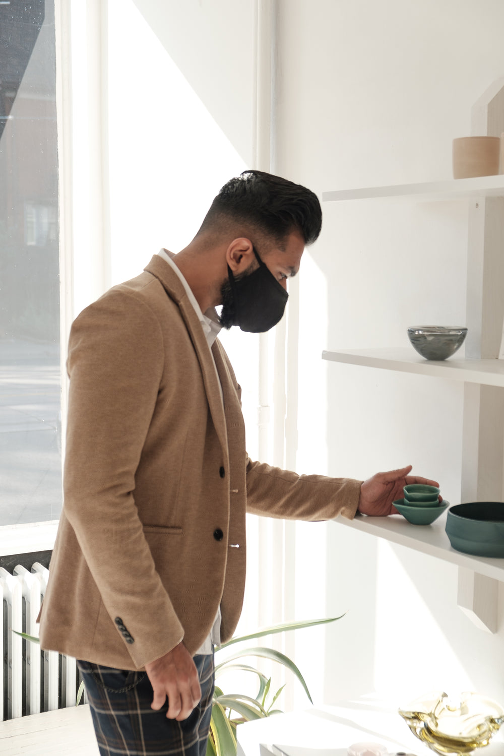 man shops for pottery and home decor