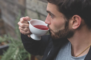 man sipping herbal tea