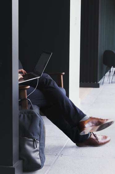 man sits with laptop