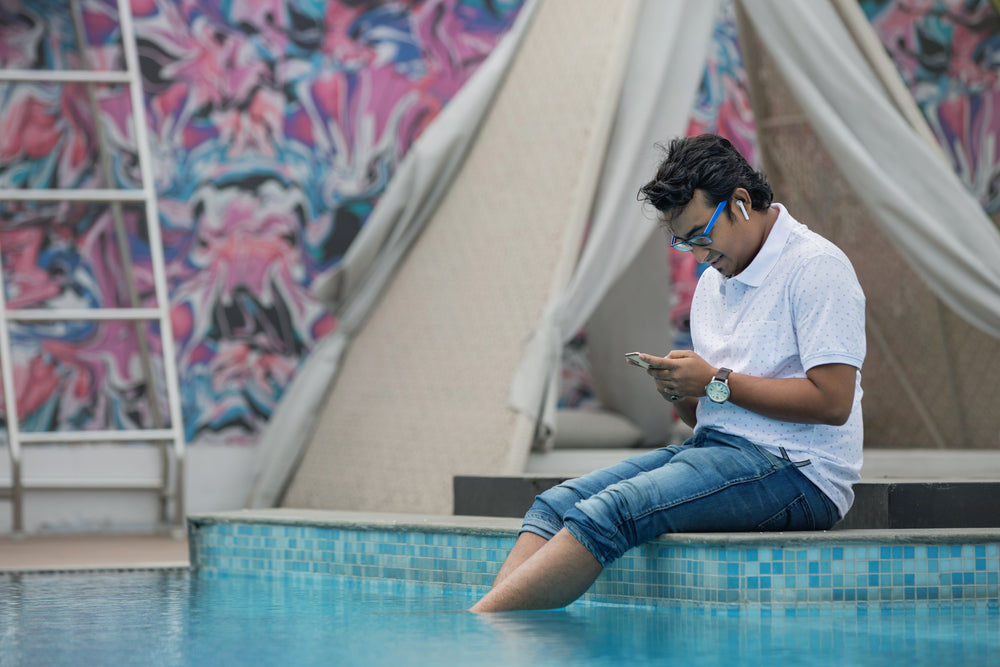 man sitting by the pool