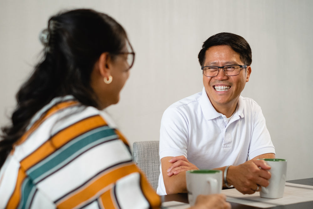 man smiles at woman with back to the camera