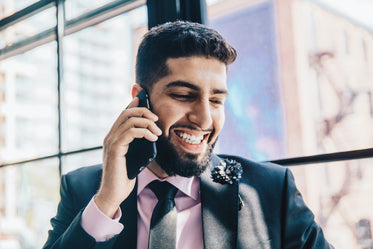 man smiles with phone