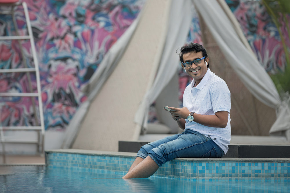 man smiling while by the pool