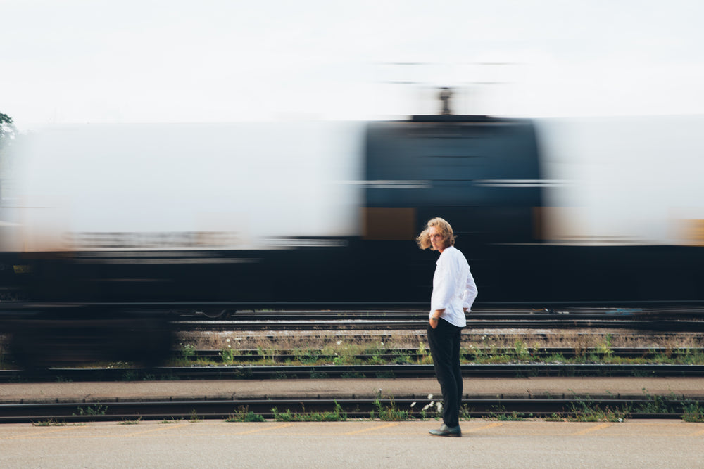 man standing by train