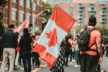 man standing with a canadian flag