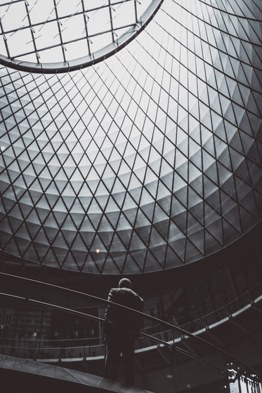 man stands under patterned dome window