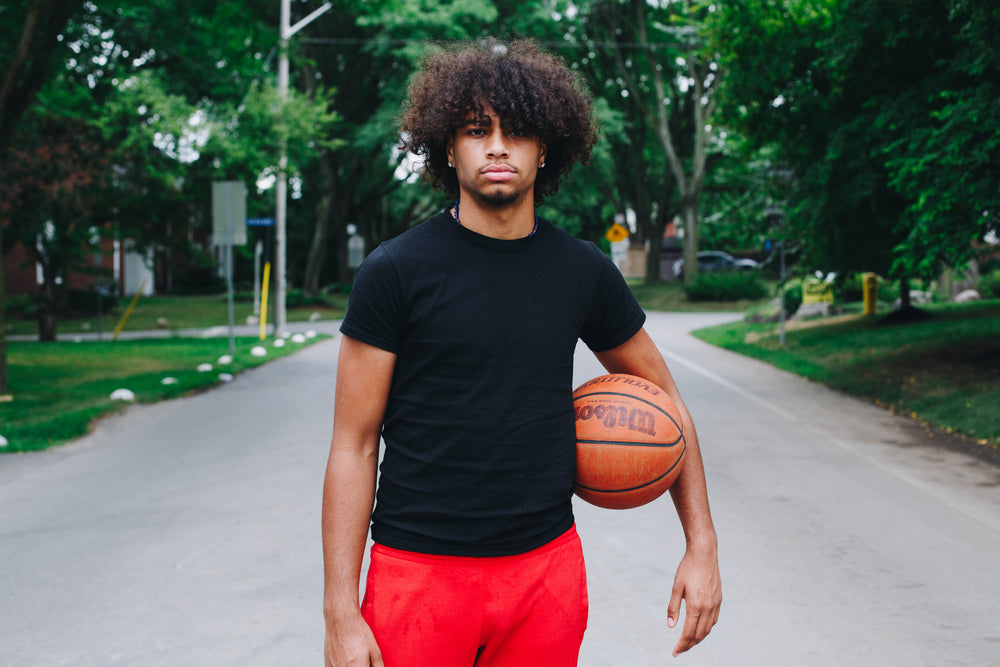 man stands with his basketball