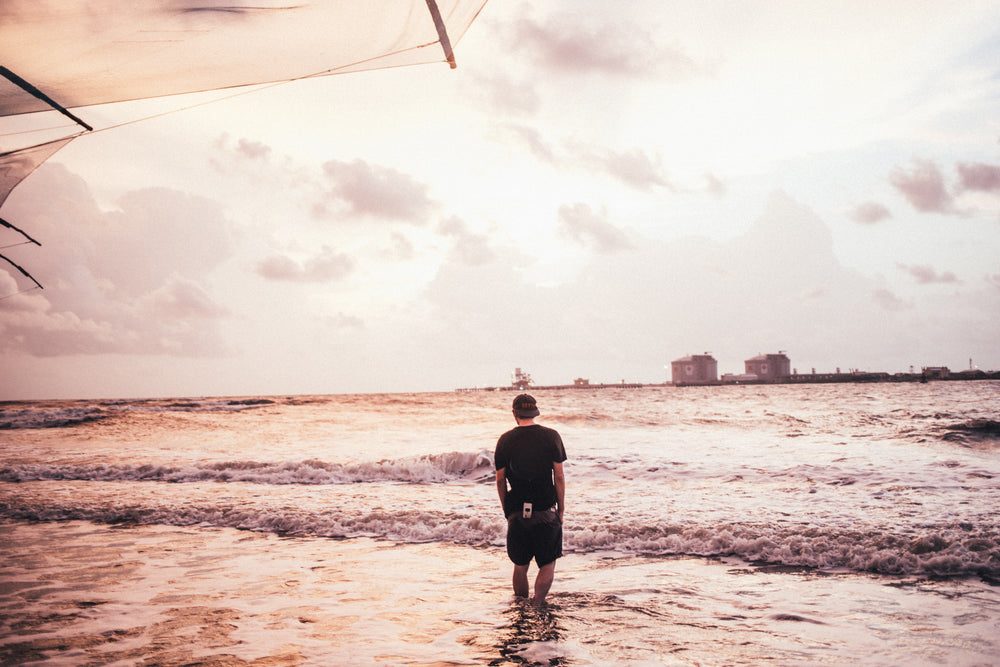 man wades in waves