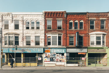 man waiting at bustop in front of abandoned building